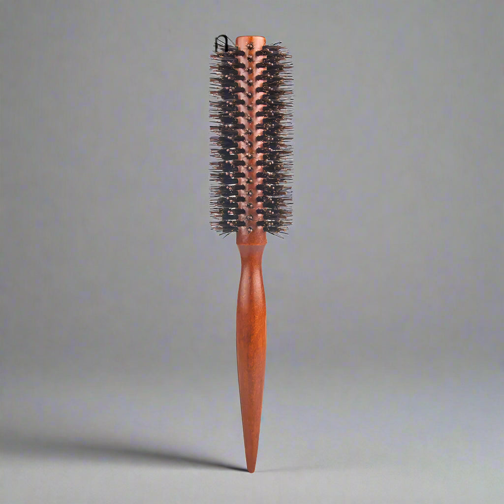 Wooden hairbrush with bristle head on a white background